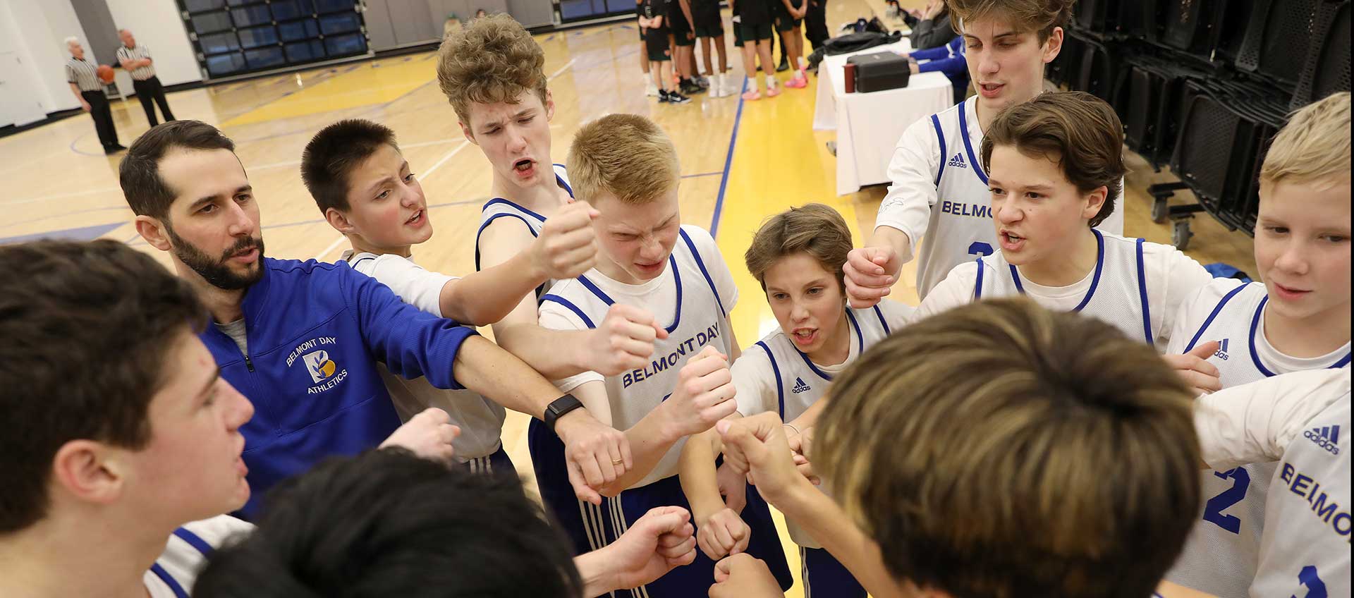 The boys' varsity basketball team huddle before a game